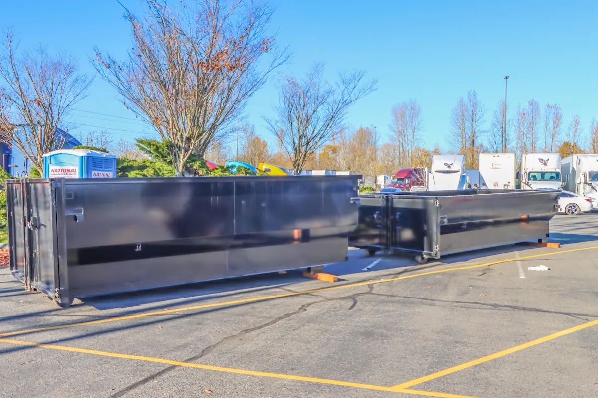 Professional dumpster rental service with roll-off container on residential driveway in Wood-Ridge